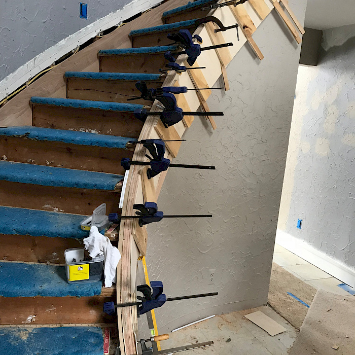 Custom stair treads glued and clamped during fabrication by Sparrow Contracting